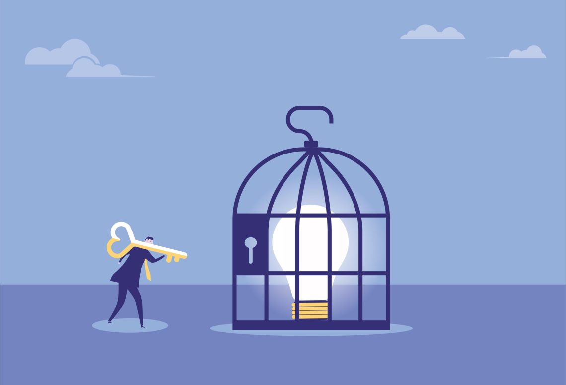 Business man opens the wisdom in the cage with a key